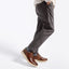 A person wearing dark charcoal gray slim-fit pants and Featherlight Napa, shown from the waist down against a clean white studio background.