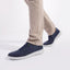 Featherlight Napa Navy Nubuck sneakers worn with beige pants on a white background