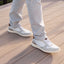 Featherlight Napa White Leather sneakers with brown accents worn on a wooden deck
