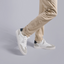 Person wearing Hayes Sneaker in Coastal Gray Leather with beige pants
