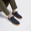 A person wearing Hayes Sneaker in Dark Navy Nubuck with gum soles, paired with olive green pants and beige socks.