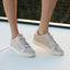 Textured Pearl sneakers worn by a person on a light surface with a blurred background