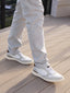 Featherlight Napa sneakers and light gray pants on a wooden deck
