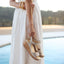 Person holding a pair of Portola Two-Strap Wedge Champagne Metallic Suede by a poolside