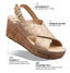 Beige sandal with cork wedge sole on a white background, featuring customizable fit and premium leather details.