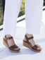 Portola two-strap wedge in cognac leather worn with white pants on a light surface.